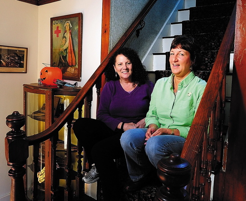 Annette Parlin, left, a medium/clairvoyant, and Cathy Cook, author of “Hauntings from Wayne and Beyond,” talk about the book this week at Cook’s home in Wayne. They plan to collaborate with another medium on a sequel.
