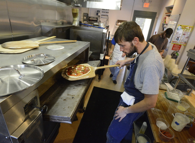 Chef Chad Conley makes a pepperoni, with pickled chillis pizza at Gather restaurant in Yarmouth.