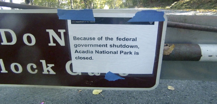 A sign on a closed gate near the entrance to the Park Loop Road in Acadia National Park tells visitors on Thursday that the park is closed because of the government shutdown.