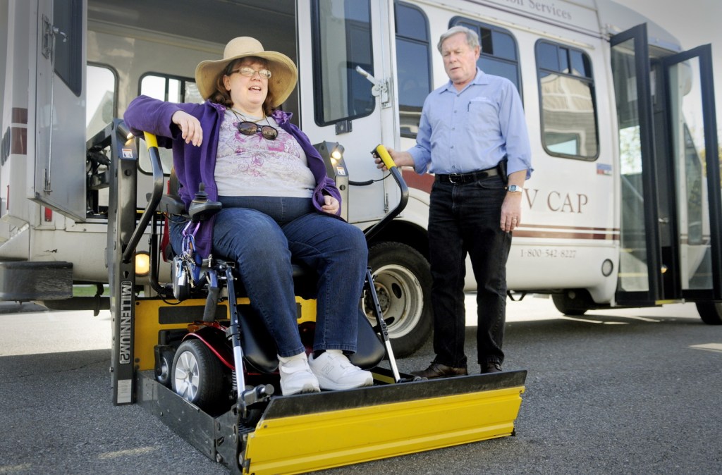 Cindy Dow is lifted into a KV CAP bus Tuesday, Oct. 15, 2013 at her Augusta home for a ride to an appointment. KV CAP driver is Don Pyle.