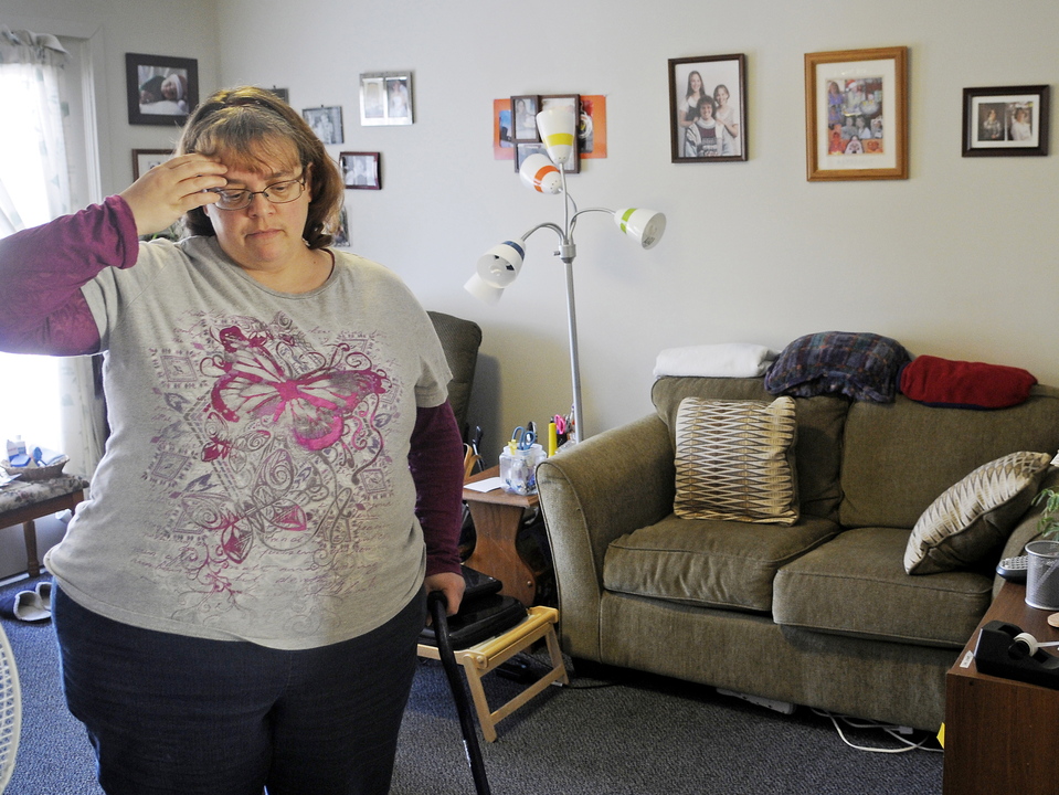 Cynthia Dow waits at her Augusta home last week for a ride through a MaineCare-sponsored driving service. Dow, whose back problems burden her walking, says she’s often complained about the state’s new medical ride service, but to no avail.