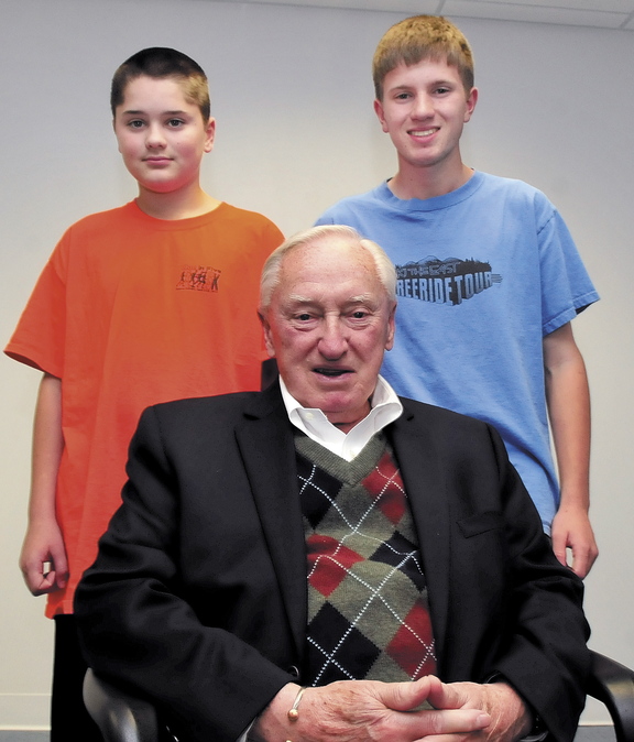 Staff photo by David Leaming GENERATIONS: Red Sox baseball fan Charlie Gaunce is surrounded by his grandsons Daniel, left, and his brother C.J. Gaunce.