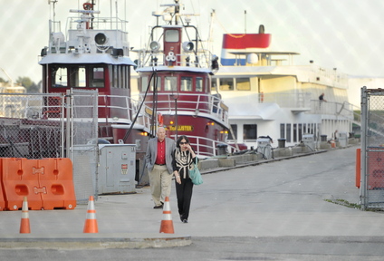 Passengers from the cruise ship Independence walk down the pier toward Commercial Street after arriving in Portland on Thursday.