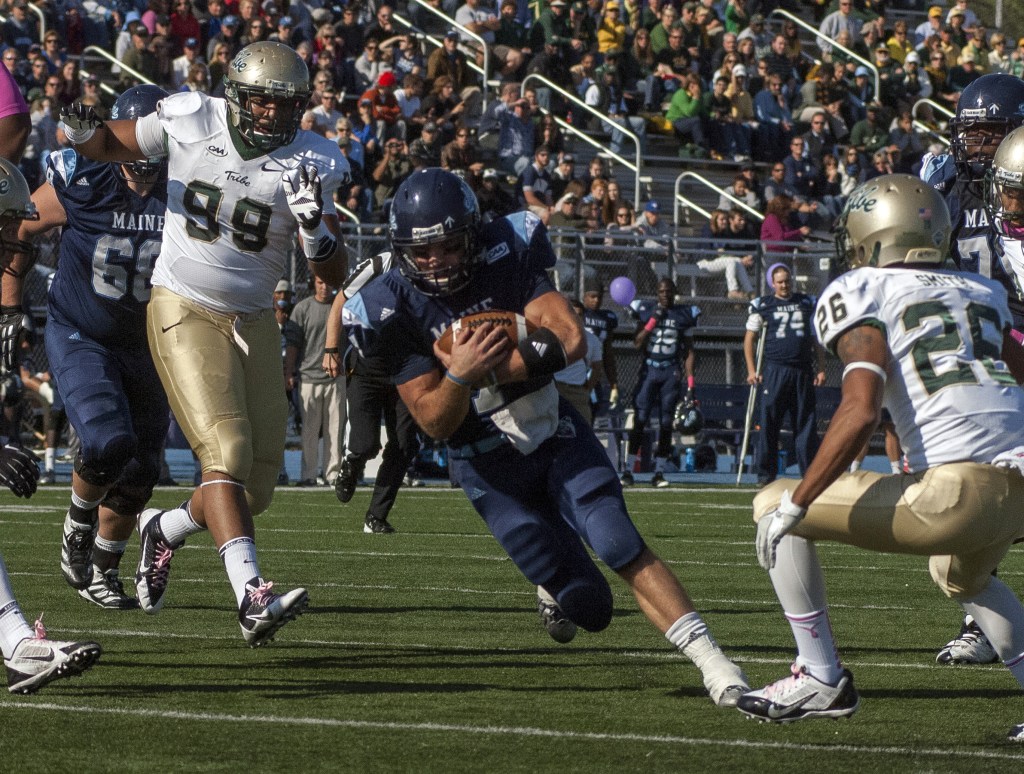 Maine quarterback Marcus Wasilewski carries the ball inside the 5-yard line past William and Mary players Tyler Clayter, 99, and Ryan Smith in the first half of Saturday’s game at Orono. UMaine improved to 6-1 with a 34-20 win.