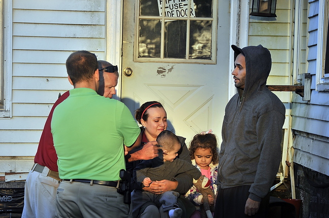 A fire at the Itsa Good Motel on Route 1 in Scarborough on Tuesday caused many to be driven from their rooms. The fire started in the room where Alex Pagen, right, and Monique Mills stayed with their children, Jake and Mia. Scarborough investigators John Gill, left, and Garrett Strout interviewed them after they returned and found they lost everything they owned.