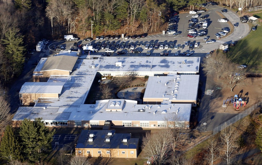 FILE - This Dec. 14, 2012 aerial file photo shows Sandy Hook Elementary School in Newtown, Conn. Contractors demolishing Sandy Hook Elementary School are being required to sign confidentiality agreements forbidding public discussion of the site, photographs or disclosure of any information about the building where 26 people were fatally shot in December 2012.