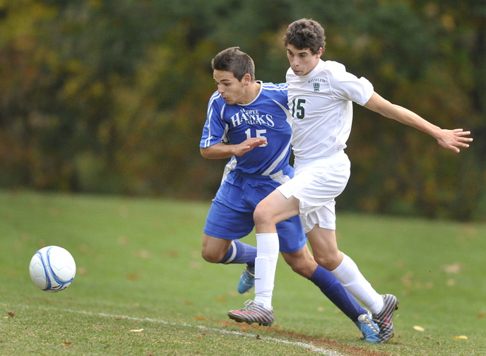 Aaron Lee of Waynflete tries to hold back Sacopee Valley’s Ryan Moulton as they chase the ball.