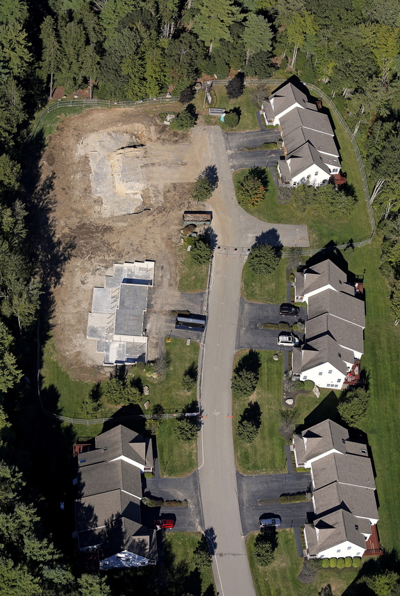 This aerial photograph, taken Sept. 18, 2013, shows Gables Drive in Yarmouth where two condo lots had to be demolished after a propane explosion earlier this summer damaged them beyond repair. The condo owned by Amory Houghton stands at left, second from top. Gabe Souza/Staff Photographer