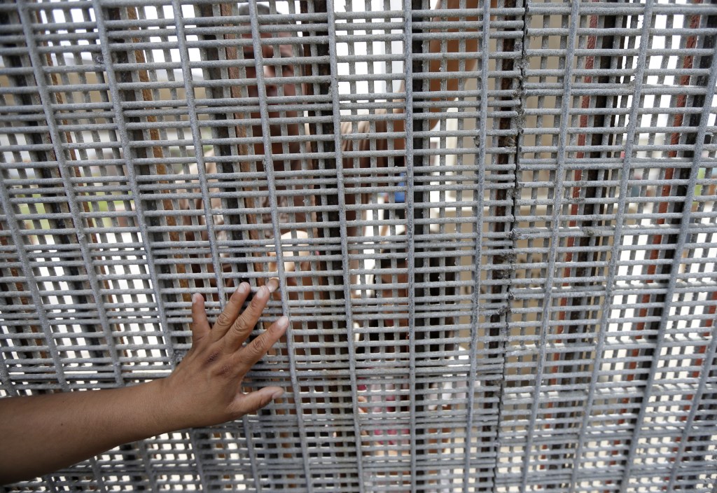 Marta Lopez, left, touches the finger of her daughter Alondra Lopez, 8, as they stand separated by a fence between Tijuana, Mexico, and San Diego during a Sunday Mass celebration. The best way to see the border without crossing it is at Border Field State Park, which is at the farthest southwest corner of the United States.