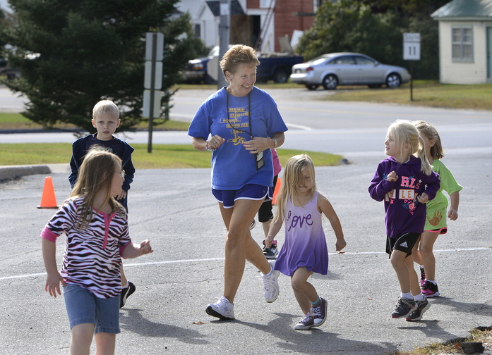 Kathy Harmon leads a kids' running club started by Kimberly Kelly last year and continuing at the Sebago Elementary School.