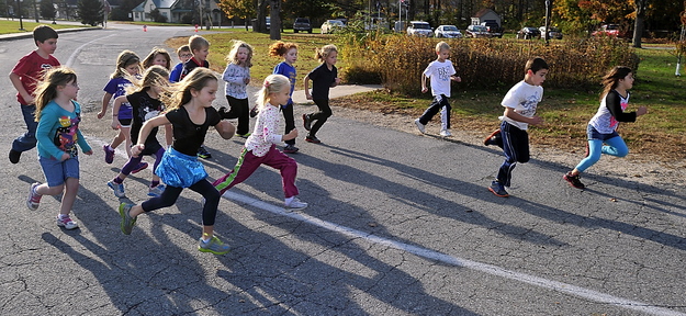 Students at Sebago Elementary School get 15 minutes to do as many laps as they can around the circular driveway to build endurance.
