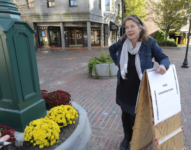 Linda Shary with her sandwich board is offering free conversations in Monument Square.