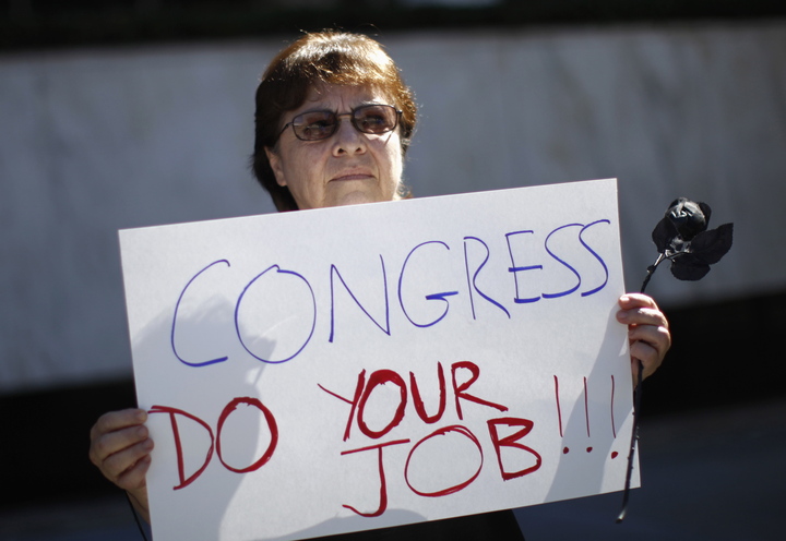 Marcia Noboa, 65, angered over the government shutdown and potential cuts to Social Security and Medicare, protests Wednesday at the Federal Building in Los Angeles, Calif.