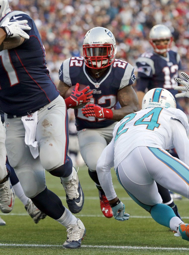 Miami Dolphins cornerback Dimitri Patterson (24) attempts to stop New England Patriots running back Stevan Ridley (22), in the second half of an NFL football game Sunday, Oct. 27, 2013, in Foxborough, Mass. (AP Photo/Michael Dwyer)