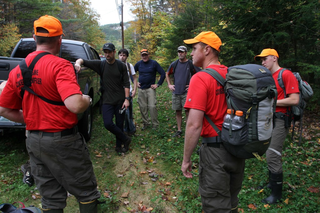 New Hampshire Fish and Game personnel and volunteers get ready to head back into the woods to search for 14-year-old Abigail Hernandez, Friday, Oct. 11, 2013, in North Conway, N.H. Hernandez was last seen Wednesday afternoon leaving school.