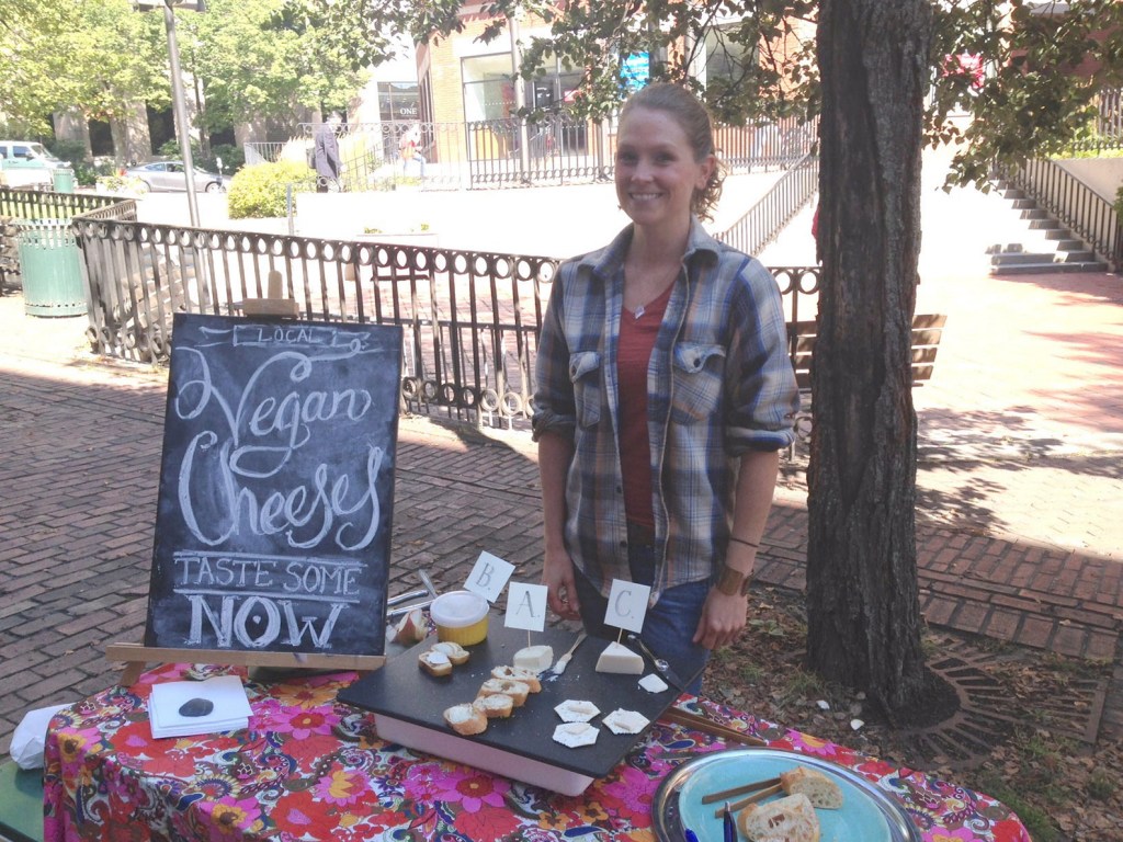 Betsy Nelson offers a taste test of her vegan fermented nut cheeses during a recent farmers market in Portland. She is working with students of Boston College’s Carroll School of Management to create a business plan to market her cheeses.