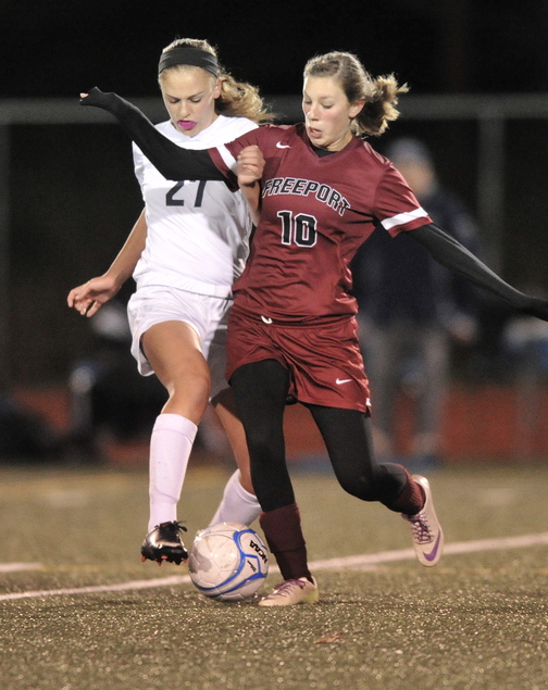 Brooke Heathco, right, of Freeport makes a pass while pressured by Yarmouth’s Katherine Clemmer during their Western Class B quarterfinal Tuesday night. Freeport won, 1-0.