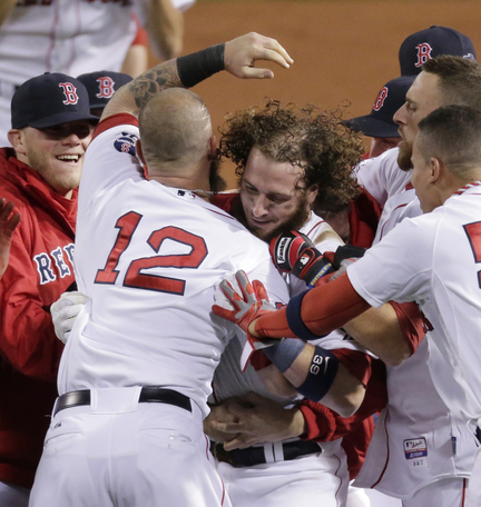 Jarrod Saltalamacchia, center, is mobbed by his teammates after his RBI single in the bottom of the ninth inning Sunday gave the Red Sox a 6-5 win in Game 2 of the ALCS.