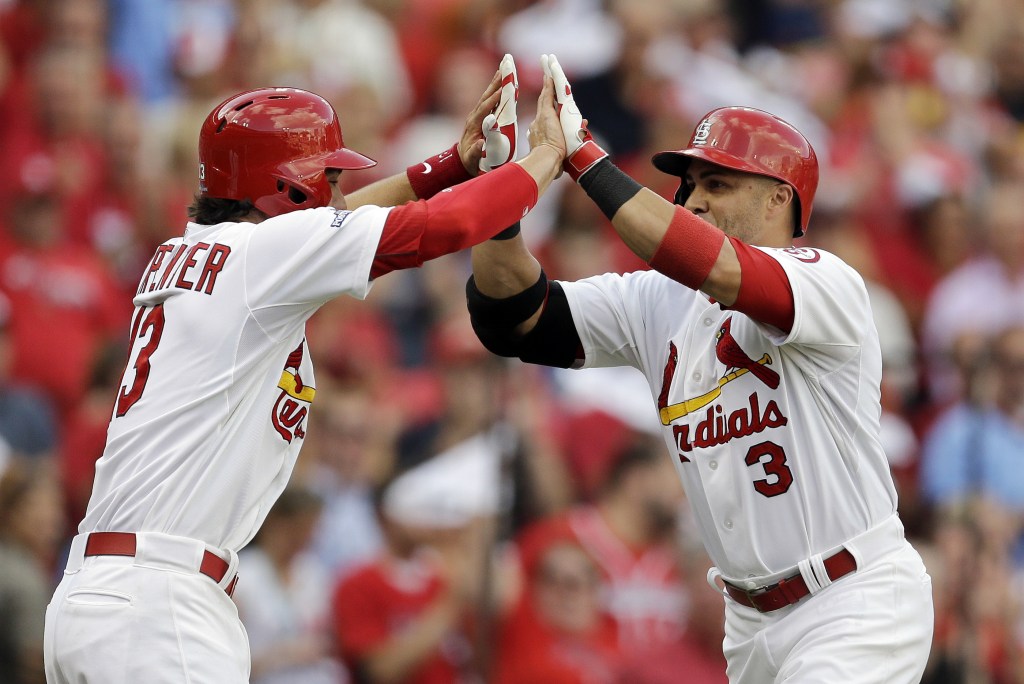 St. Louis Cardinals’ Carlos Beltran (3) celebrates in the dugout with Jon Jay (19) after Beltran hit a three-run home run against the Pittsburgh Pirates in the third inning of Game 1 of baseball’s National League division series on Thursday, Oct. 3, 2013, in St. Louis.