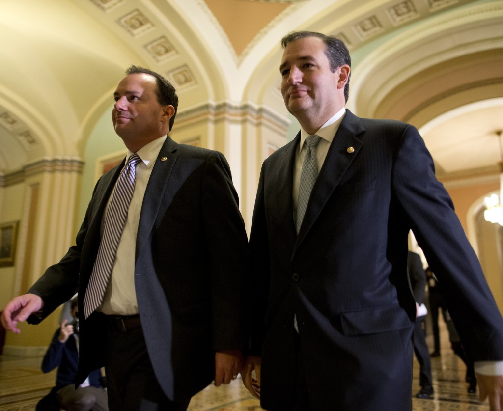 Sens. Mike Lee, R-Utah, left, and Ted Cruz, R-Texas, walk to the Senate floor on Wednesday to vote on a bill that raised the debt ceiling and reopened the federal government.