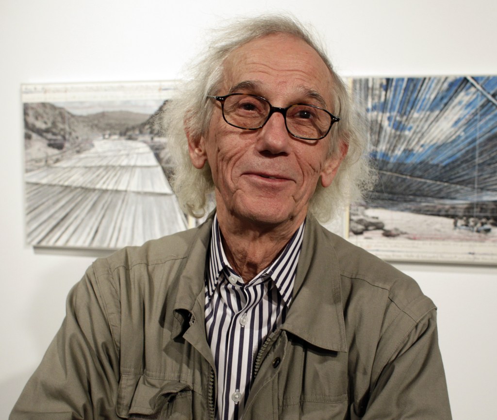 Christo stands in front of his proposed “Over the River” project at the Metropolitan State University Center for Visual Art in Denver. He says he welcomes debate over what is appropriate.
