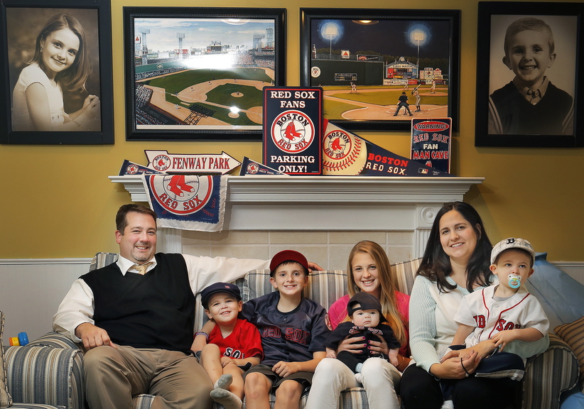 Saco residents Isabel and Jeff Cochrane are big fans of baseball and the Red Sox, as evidenced by their memorabilia and the names they gave many of their children. Above are, from left: dad Jeff; sons Fenway Parke, 3, Jackson, 11, and Pedroia Wakefield, 2 months; daughter Cassidy, 15; son Griffey Junior, 19 months; and mom Isabel.