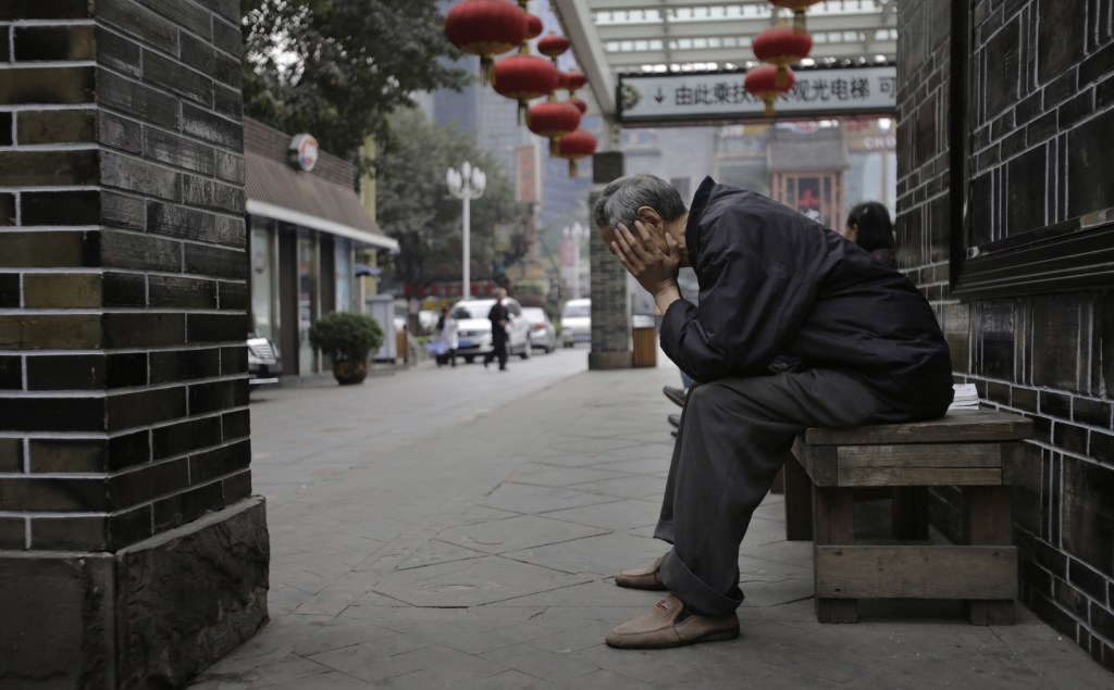 An elderly man sits on a bench in Chongqing, China. With the world’s population aging faster than ever before, families and governments are struggling to decide who is responsible for the care of the elderly.