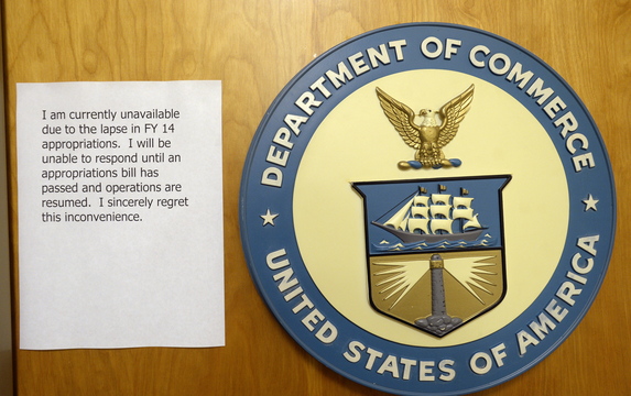 The Department of Commerce in Portland sits closed with a note apologizing for the inconvenience Friday.
