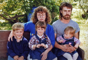 The Mosher siblings, from left, Isaiah, Morgan and Sydney, pose for a family portrait with their parents, Martha and Christopher, more than a decade before their father committed suicide.