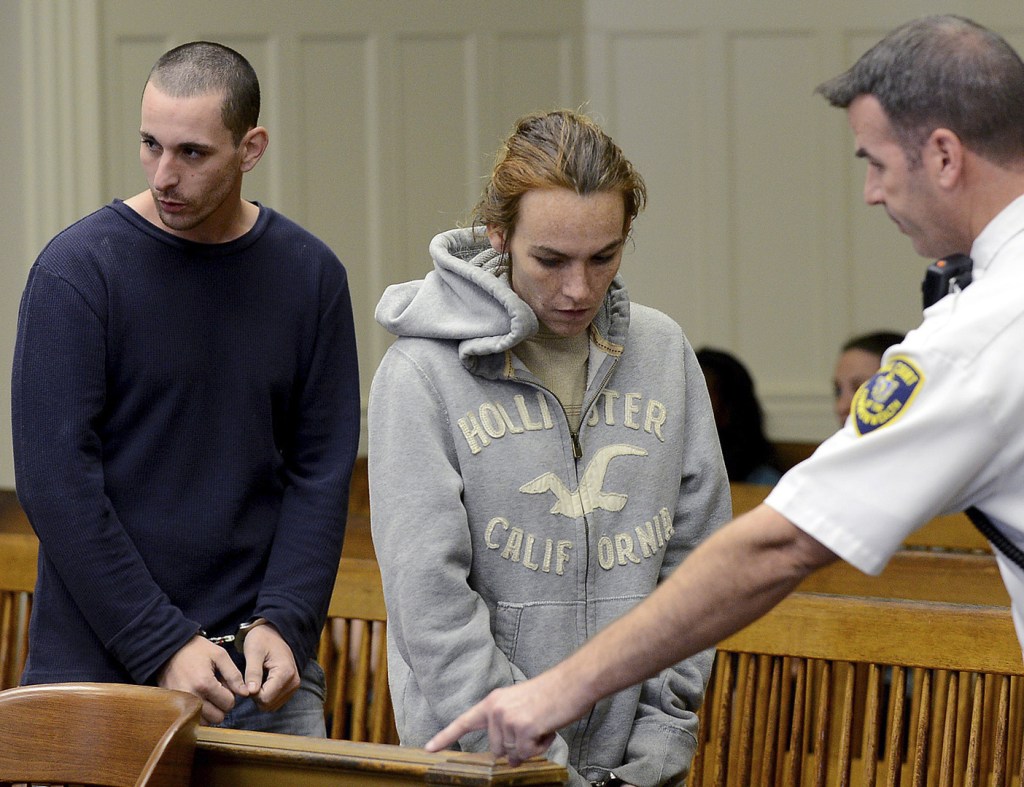 Ryan Barry and Ashley Cyr are led into Brockton, Mass., Superior Court for arraignment Friday on charges of manslaughter in the death of their 5-month-old daughter Mya Barry, by giving her a bottle of formula with heroin in September 2011. They pleaded not guilty.
