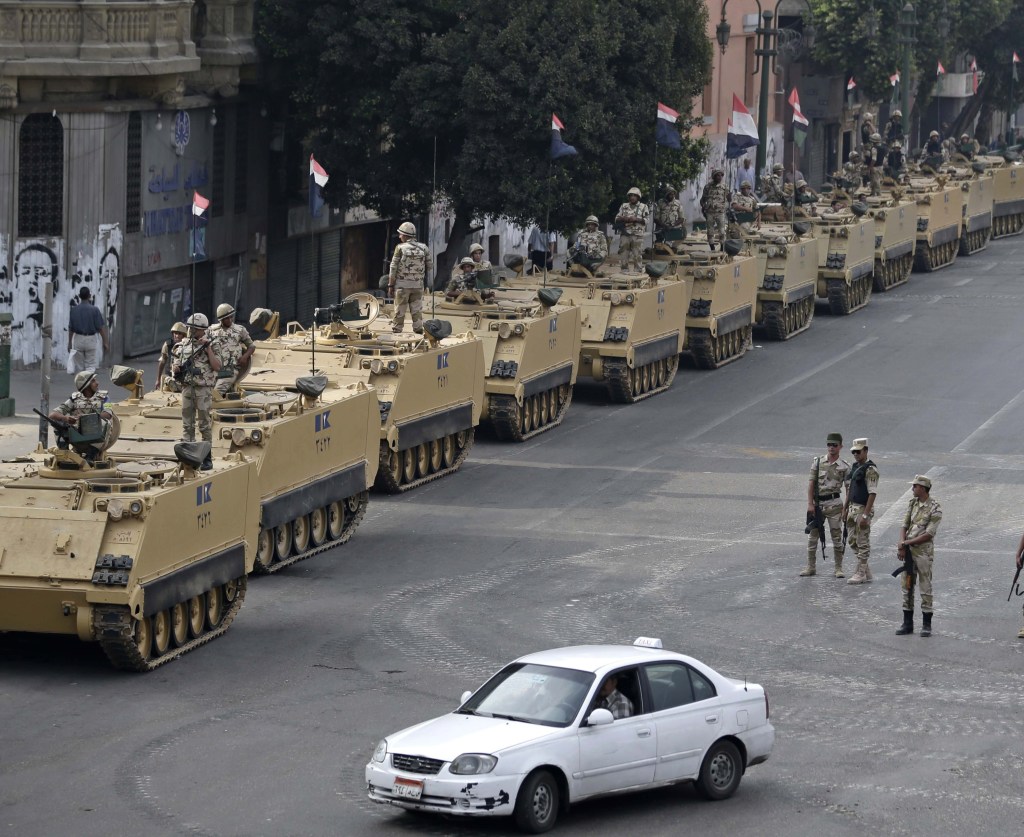 Egyptian army soldiers take their positions to guard an entrance of Tahrir Square in Cairo on Aug. 16. Since the July 3 coup, hundreds of pro-Morsi protesters have been killed.