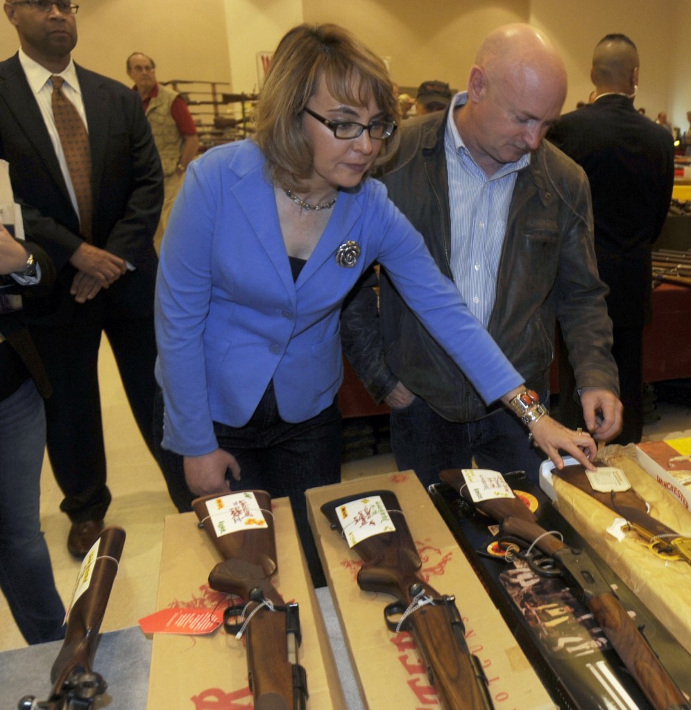 Former Arizona congresswoman Gabrielle Giffords, left, and her husband Mark Kelly, center, tour the Saratoga Springs Arms Fair.