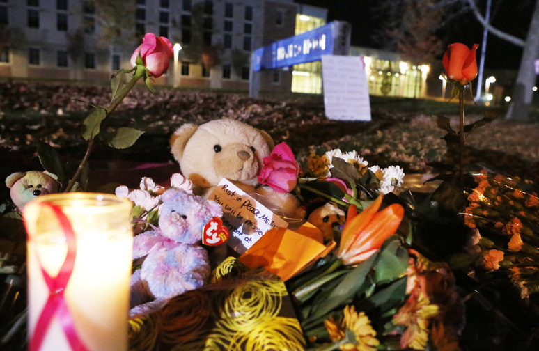 Candles and teddy bears are placed at Danvers High School prior to a candlelight vigil to mourn the death of Colleen Ritzer, a 24-year-old math teacher at Danvers High School on Wednesday in Danvers, Mass. Ritzer was found slain in woods behind the high school, and Danvers High School student Philip Chism, 14, was charged with killing her.
