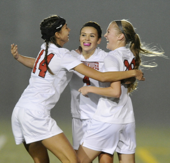 Ashley Perriello of Scarborough is congratulated by Aly Atherton, left, and Morgan Rodway after scoring a second-half goal Wednesday during a 2-2 tie against Windham.