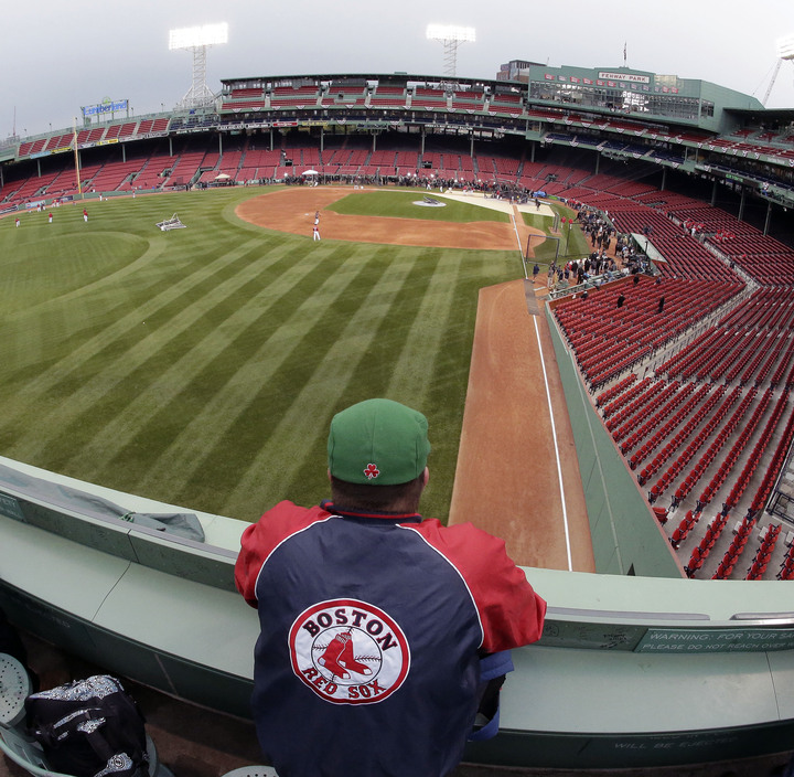 A Boston Red Sox fan watches during batting practice before Game 1 of baseball’s World Series between the Red Sox and St. Louis Cardinals Wednesday, Oct. 23, 2013, in Boston.