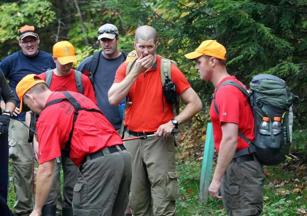 The Associated Press New Hampshire Fish and Game personnel and volunteers take a break after searching the woods for 14-year-old Abigail Hernandez on Friday in North Conway, N.H.