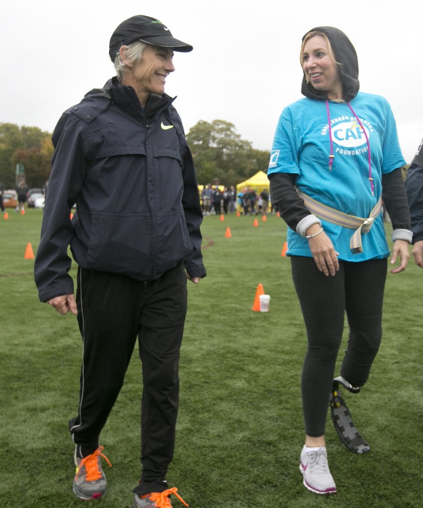 Two-time Boston Marathon winner Joan Benoit Samuelson, left, talks with Heather Abbott, who lost part of her left leg in the Boston Marathon explosion, during a running clinic Sunday in Cambridge, Mass.