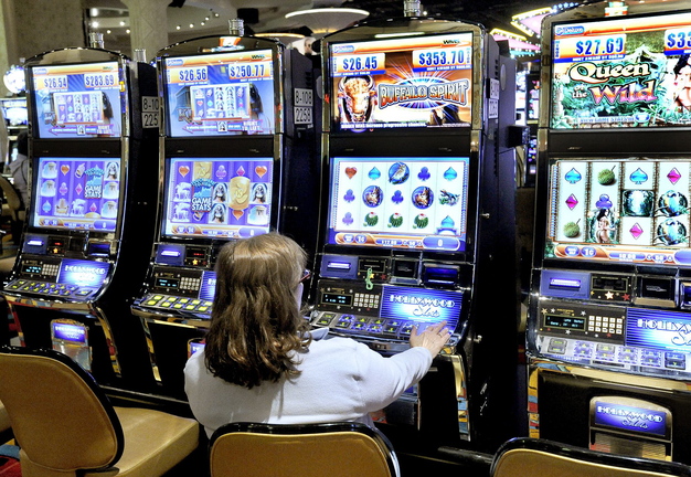 A patron plays the slot machines at Hollywood Casino in Bangor in 2012. A commission established to analyze the impact of gaming in Maine and chart a path forward is cutting short that effort.