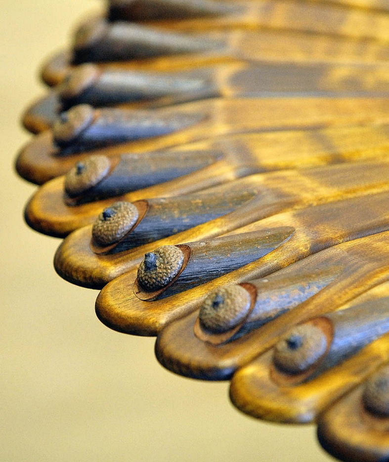 Randy Holden of Norridgewock creates unique furniture using the existing curves and characteristics of the natural wood. This table uses acorn shells as decoration.