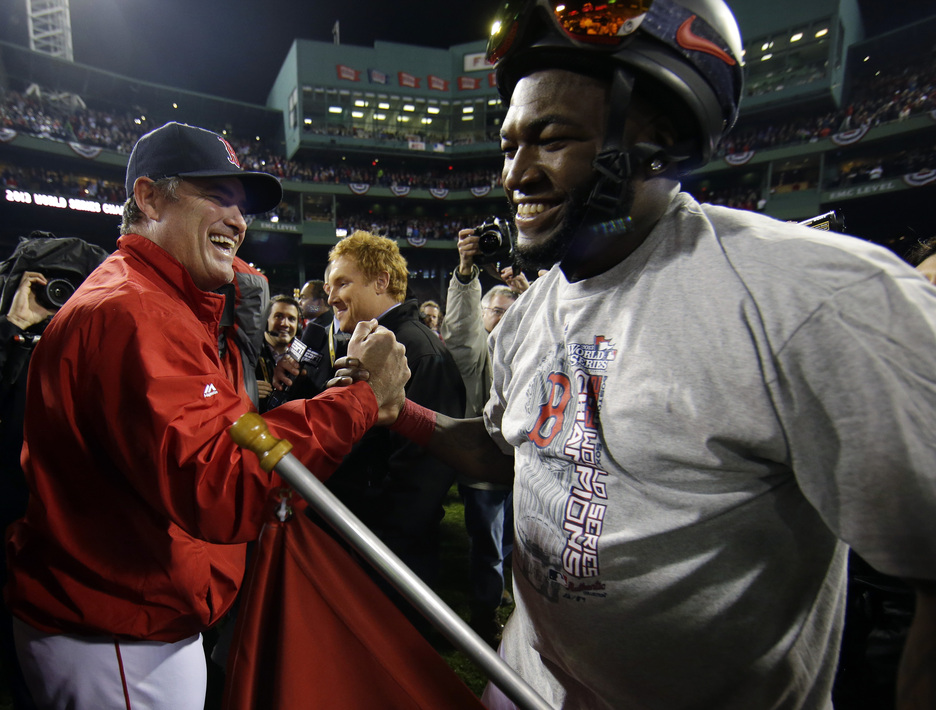 Boston Red Sox manager John Farrell celebrates with David Ortiz after Game 6 of baseball’s World Series against the St. Louis Cardinals Wednesday, Oct. 30, 2013, in Boston. The Red Sox won 6-1 to win the series.
