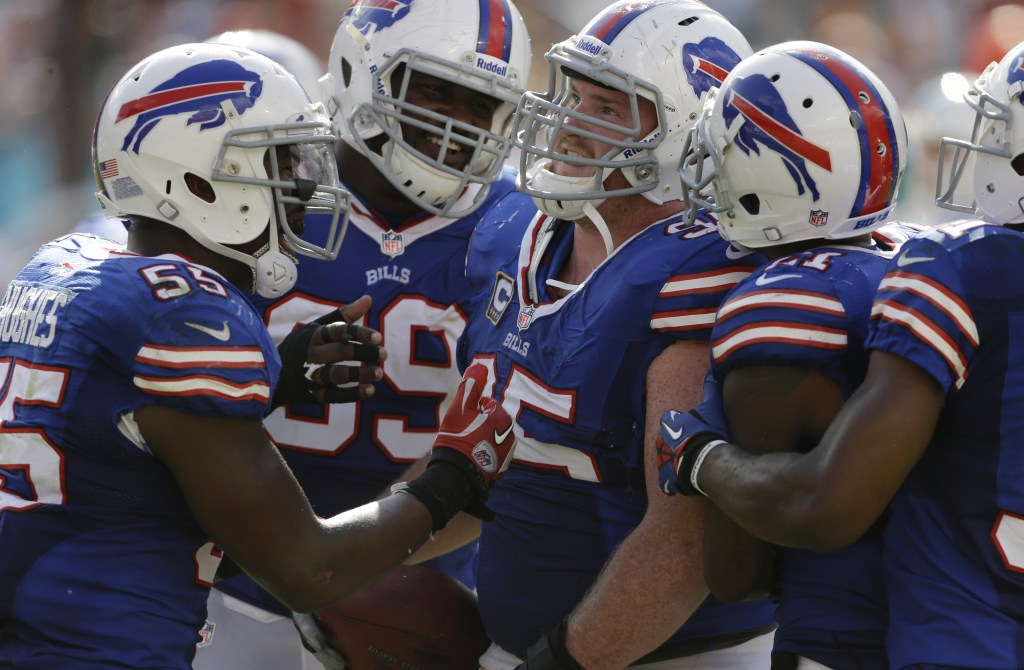 Buffalo defensive tackle Kyle Williams, center, is congratulated by his teammates after recovering a fumble to set up the winning field goal in a 23-21 victory at Miami.