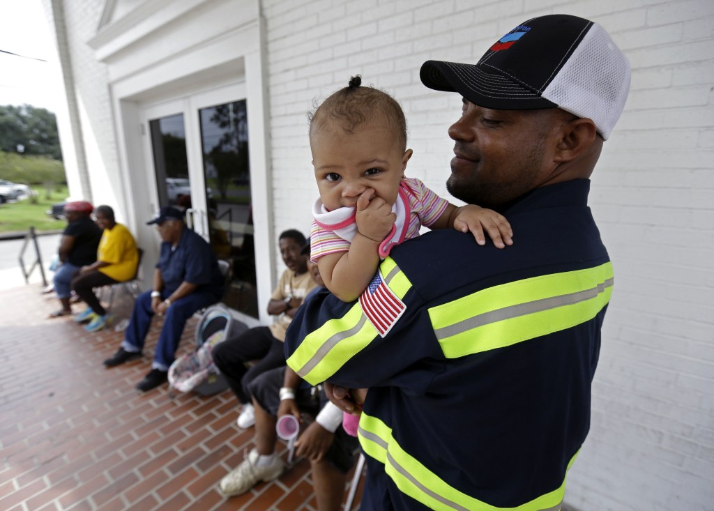 Gregory Ragas, of Davant, La., holds his daughter Jasmine Ragas, 1 year, at an evacuation shelter in Belle Chasse, La., in anticipation of Tropical Storm Karen, Saturday, Oct. 5, 2013. The East Bank of Plaquemines Parish has been under a mandatory evacuation, which has been downgraded to a voluntary evacuation. in Belle Chasse, La., Saturday, Oct. 5, 2013.