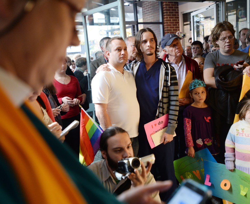 Same-sex marriage supporters in Ann Arbor, Mich., learn Wednesday that a decision that could have overturned the state’s ban on same-sex marriage was postponed.