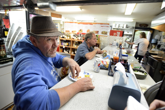 Georgetown selectman Bill Plummer is among the patrons at Georgetown Country Store on Monday, Oct. 7, 2013 to talk about resident Leon Kelley after he was fatally shot at Brown's Bee Farm in Cumberland yesterday.