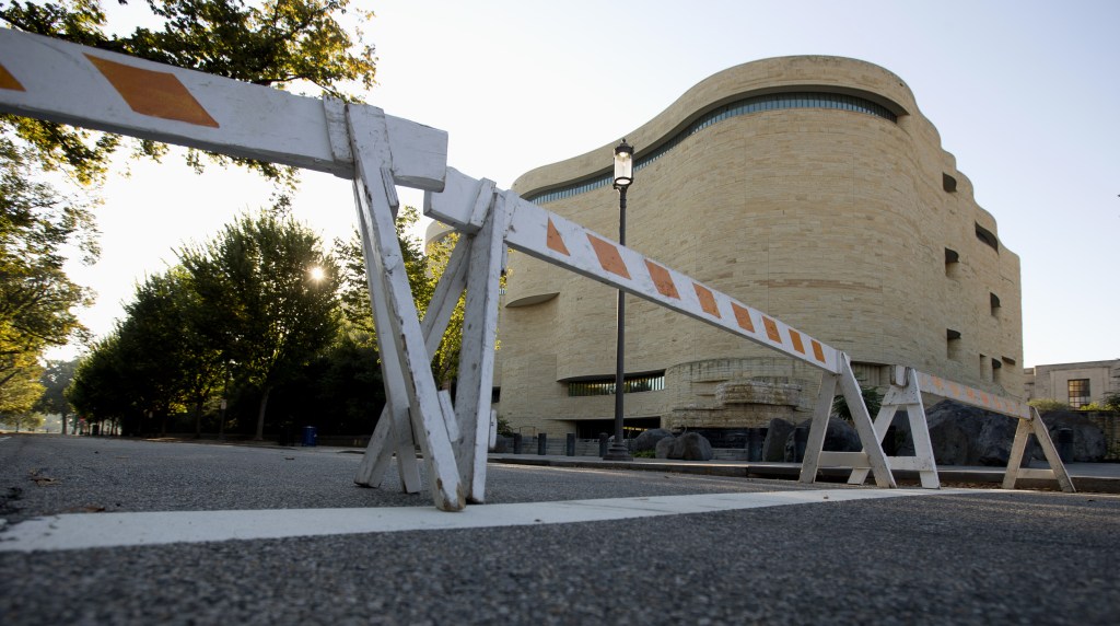 Barricades are posted in front of the closed Smithsonian National Museum of the American Indian in Washington, Wednesday, Oct. 2, 2013. The political stare-down on Capitol Hill shows no signs of easing, leaving federal government functions _ from informational websites, to national parks, to processing veterans’ claims _ in limbo from coast to coast. Lawmakers in both parties ominously suggested the partial shutdown might last for weeks.