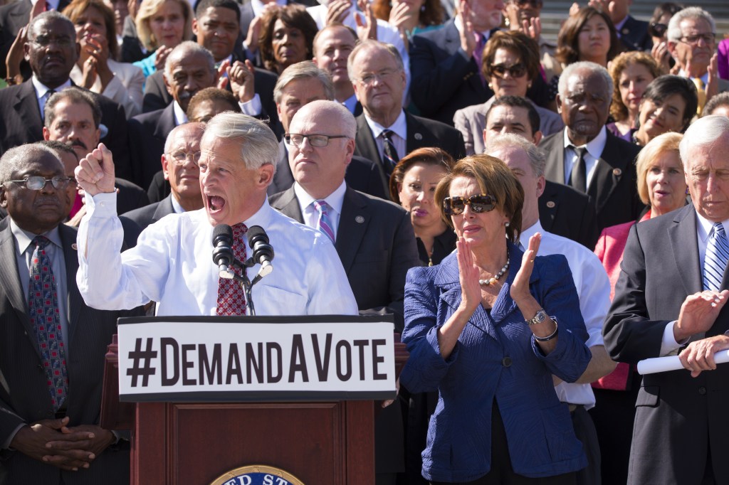 As Rep. Steve Israel, D-N.Y., speaks at left, House Democrats rally behind Minority Leader Nancy Pelosi, D-Calif., right, as they tell the Republican majority they want a vote on reopening the government without clamping any restrictions on President Barack Obama’s health care law, at the Capitol in Washington on Wednesday.