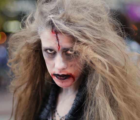 Mariss Staples, 16, who lives in Kennebunkport, stares down the camera as she waits to break into dance as part of a zombie flash mob in Portland on Wednesday.