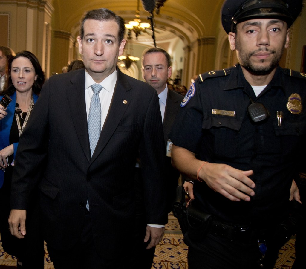 Sen. Ted Cruz, R-Texas, walks with security after talking to reporters on Capitol Hill on Wednesday. A number of Republicans have castigated Cruz during the shutdown impasse, including Rep. Peter King, R-N.Y., who said Cruz was “fraudulent from the start.”
