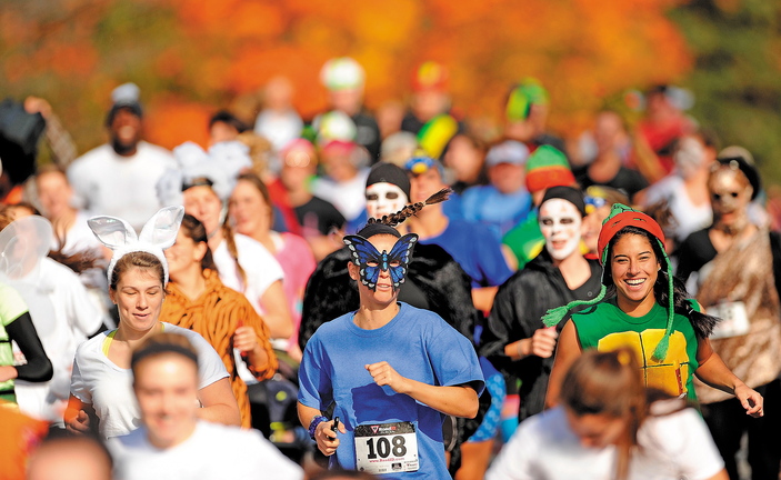 Nearly 200 costume-wearing runners make their way down Mayflower Hill Road at Colby College in the Freaky 5K Fun Run organized by Hardy Girls Healthy Women on Saturday. The fun run was started to help draw girls away from scantily clad Halloween characters and toward scary and creative costume designs.