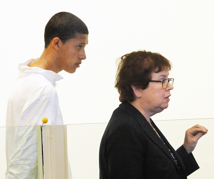 Philip Chism, 14, stands during his arraignment for the death of Danvers High School teacher Colleen Ritzer as his attorney Denise Regan speaks on his behalf in Salem District Court in Salem, Mass., Wednesday. Chism was ordered held without bail.